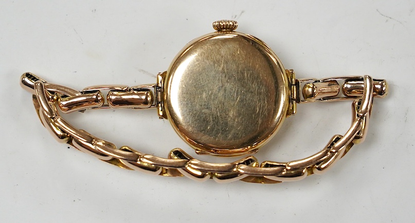 A lady's early 20th century 9ct gold manual wind wrist watch, with Arabic dial, on a 9ct expanding bracelet, gross weight 21.7 grams. Condition - fair to good
